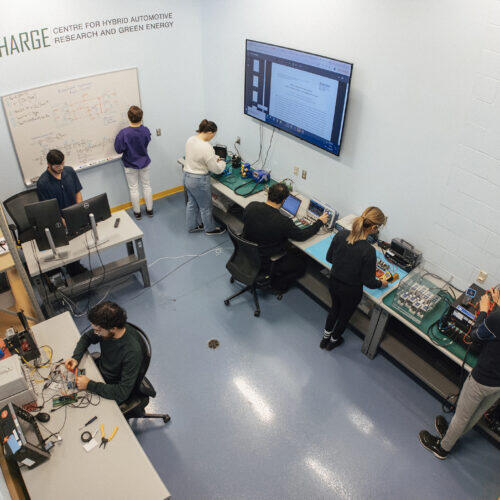 The CHARGE Lab at the University of Windsor with researchers at test benches