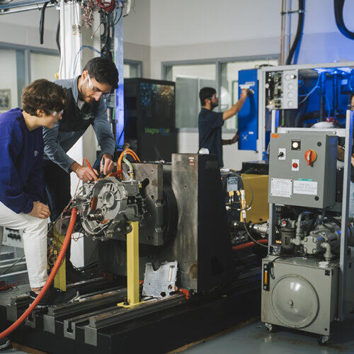 Ahmad working hands-on with an EV motor on a dynamometer test rig at the CHARGE Lab