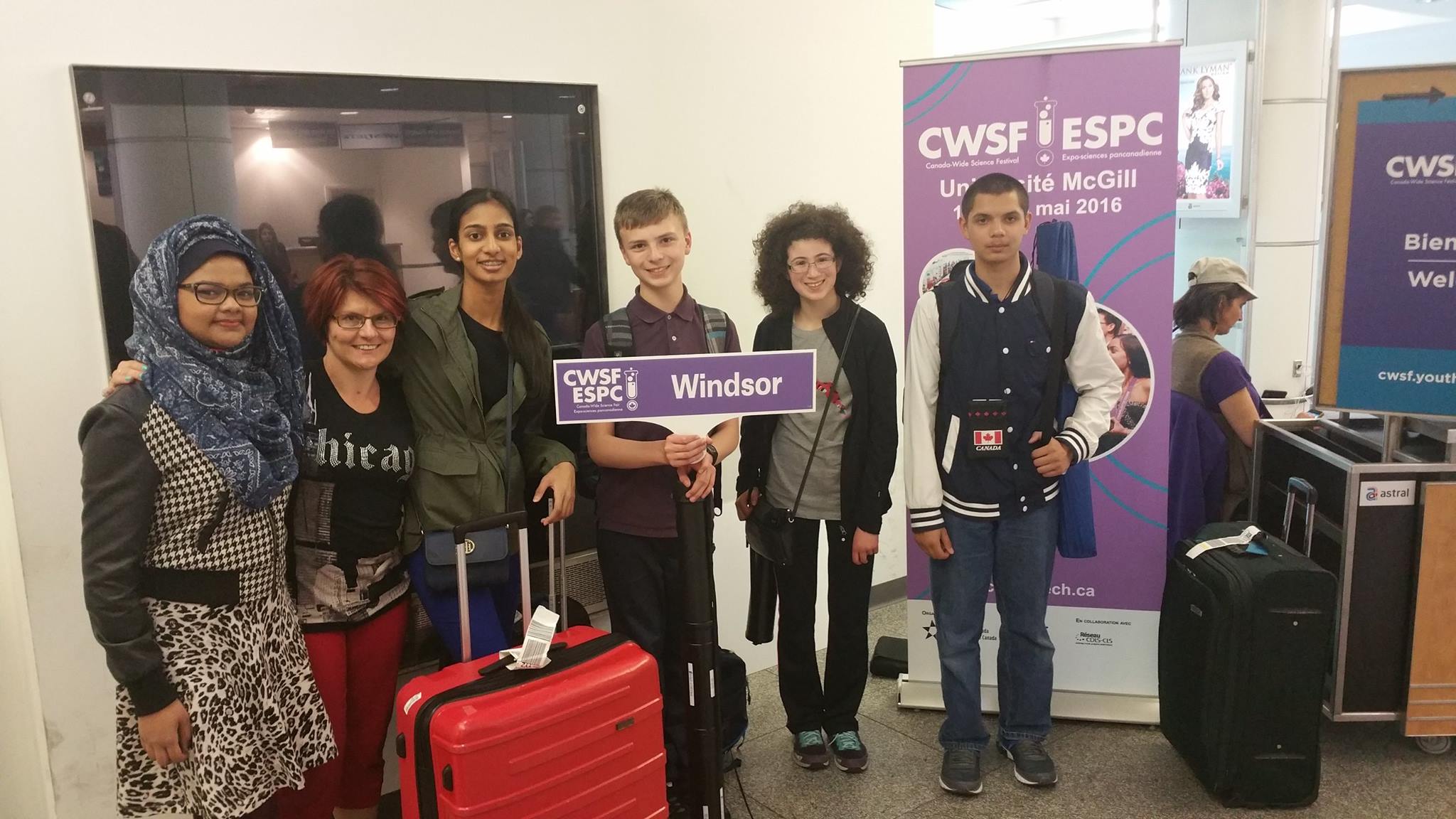 Team Windsor at the airport with the CWSF sign